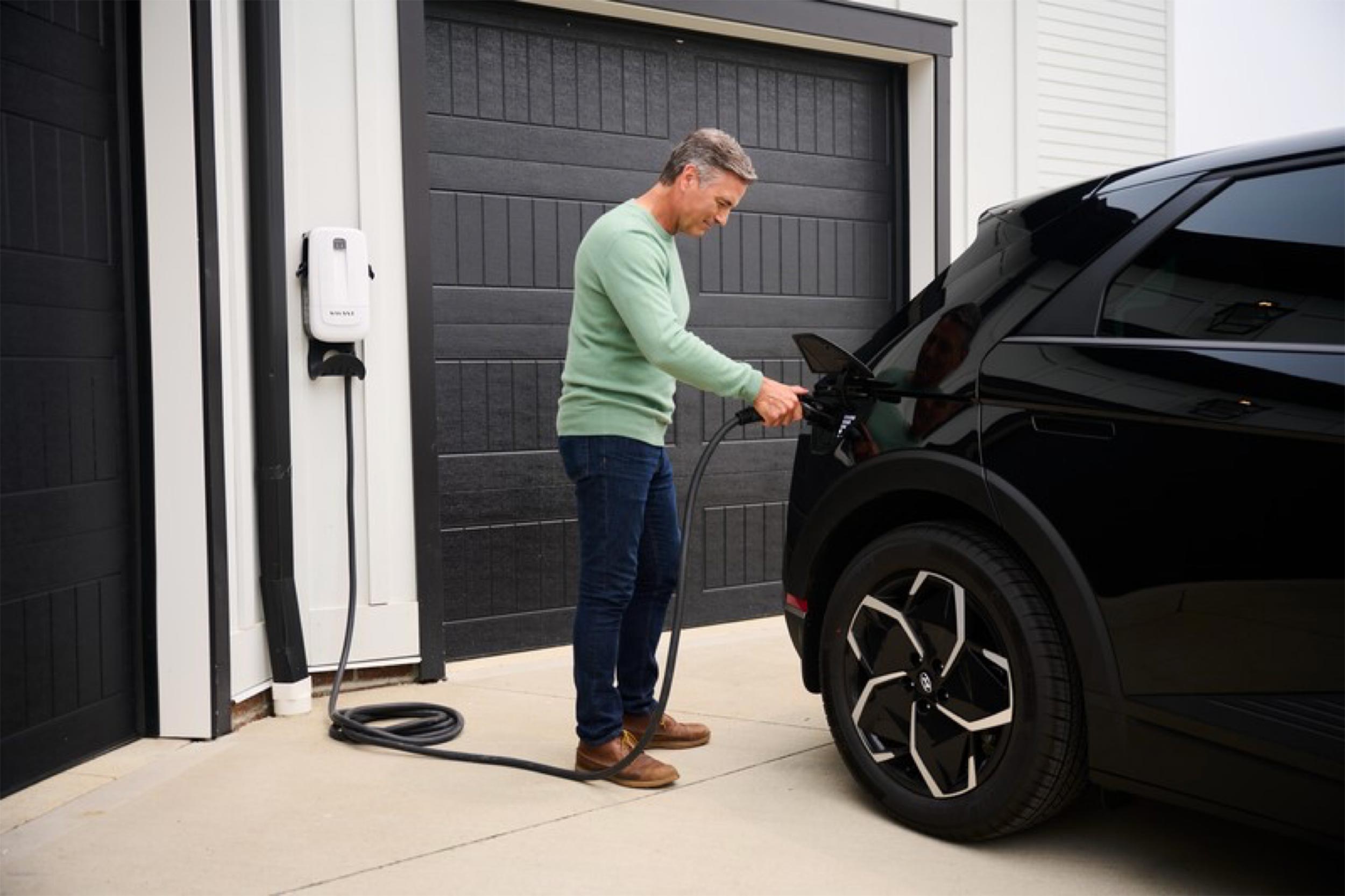 Man charging his car with Savant Power EV Charging