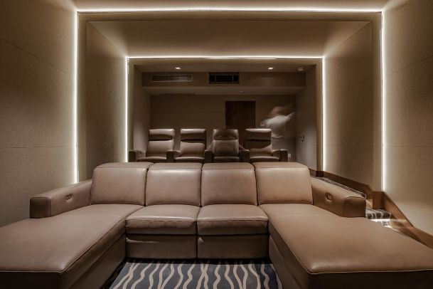 Tanned colored Home Theater with in-wall and in-ceiling LED Lighting