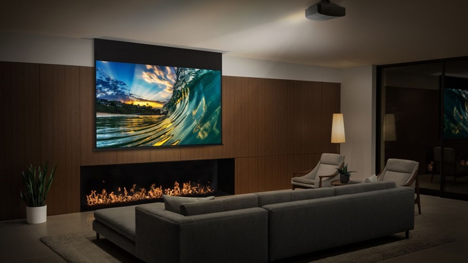 Drop down projector screen with projector in dedicated home theater room. 