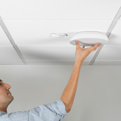 Technician installing an access point for a Los Angeles business space.