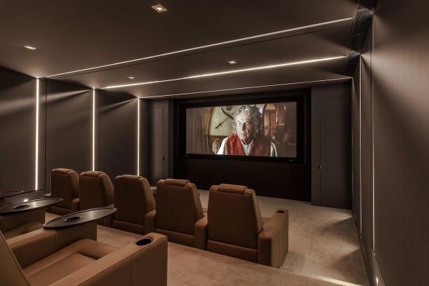 Tanned colored dedicated Home Theater with in-wall and in-ceiling LED Lighting located in Los Angeles