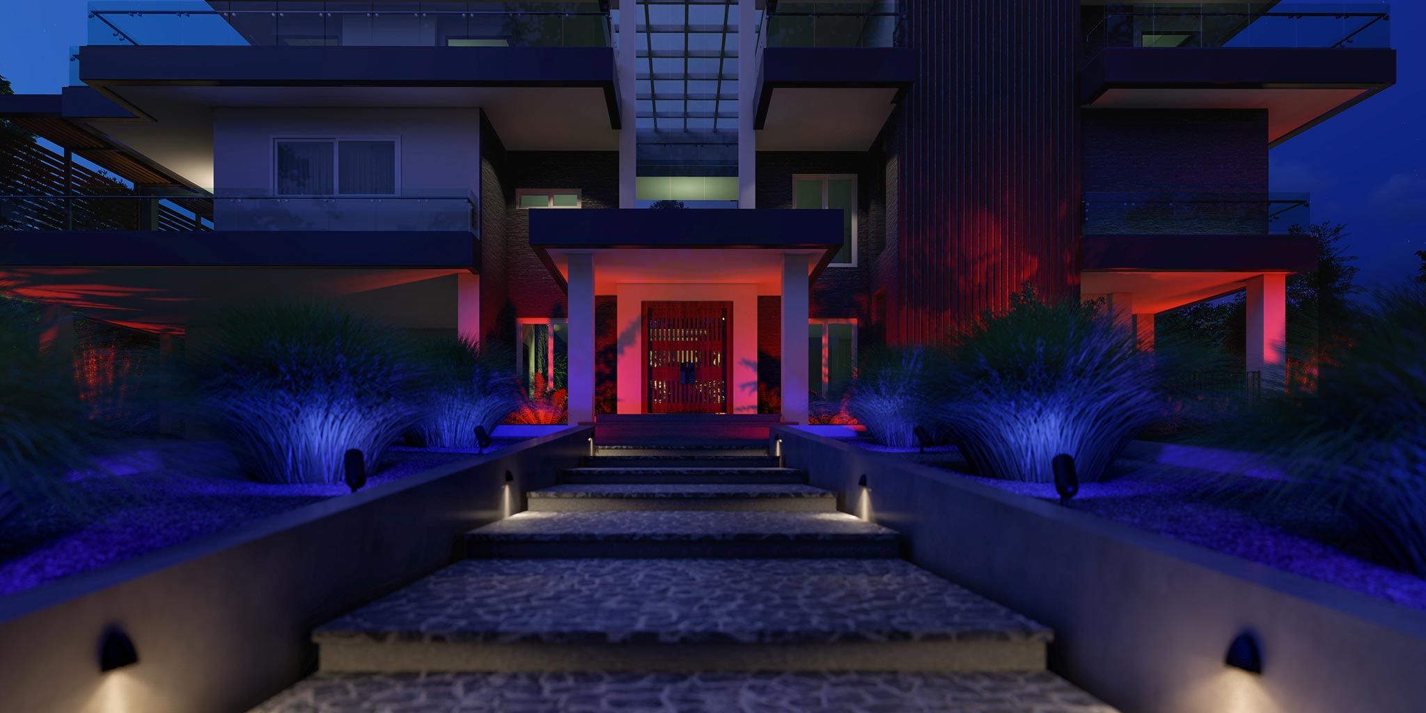 A modern home entrance at night with bold lighting design, featuring vibrant blue and red lights highlighting the landscape and architecture.