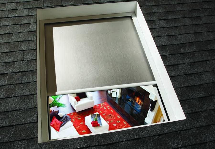 Lutron tensioned shades installed on a skylight, viewed from above, revealing the living room below.