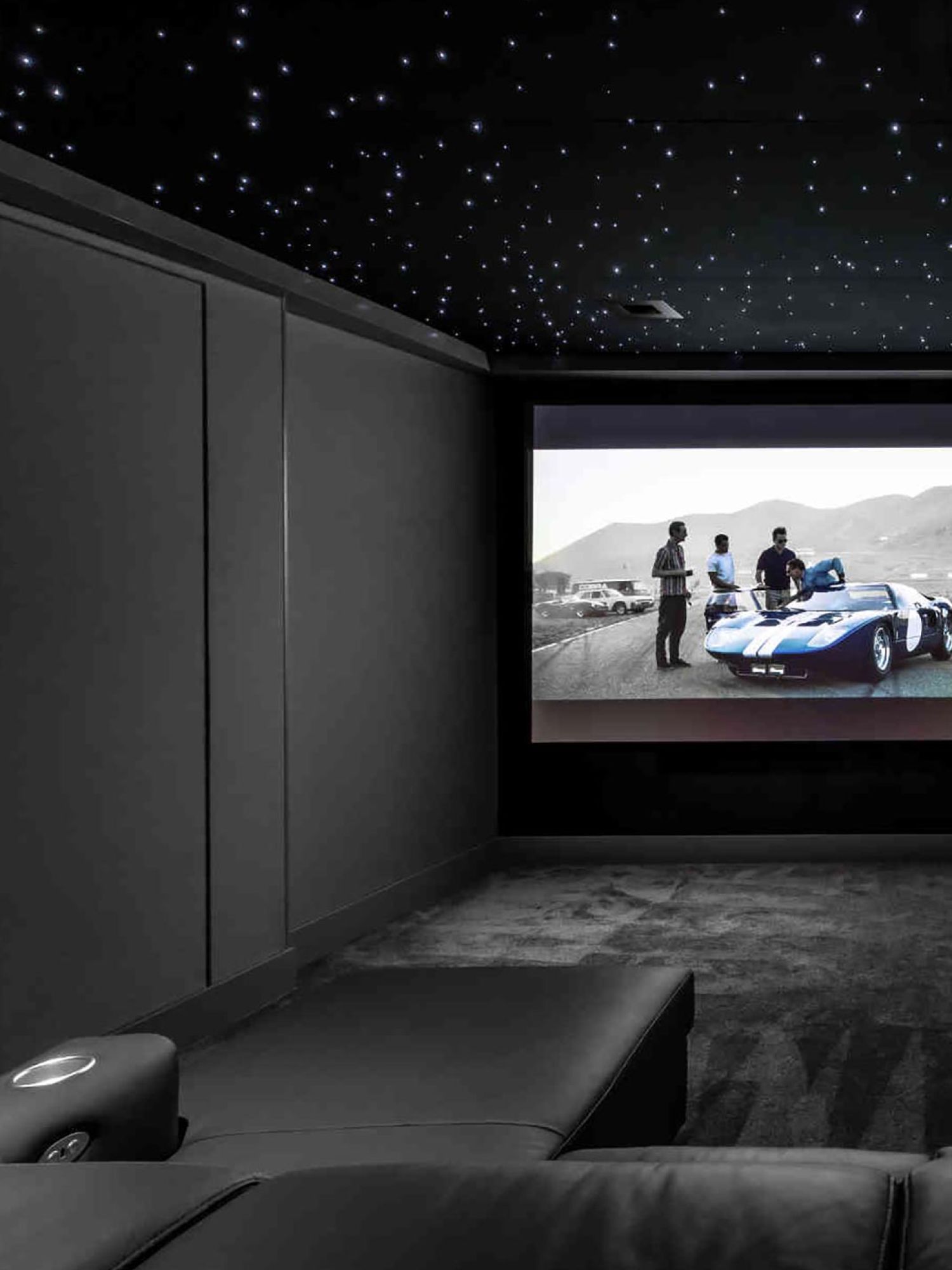 Dedicated custom home theater design with theater seating and starlight ceiling