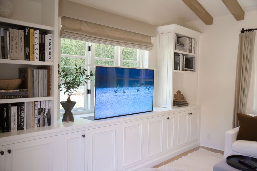 Nexus TV lift built into sitting area cabinetry for a sleek and aesthetically pleasing look. 