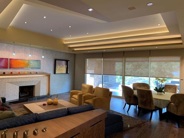 Lutron shades halfway closed in a family room