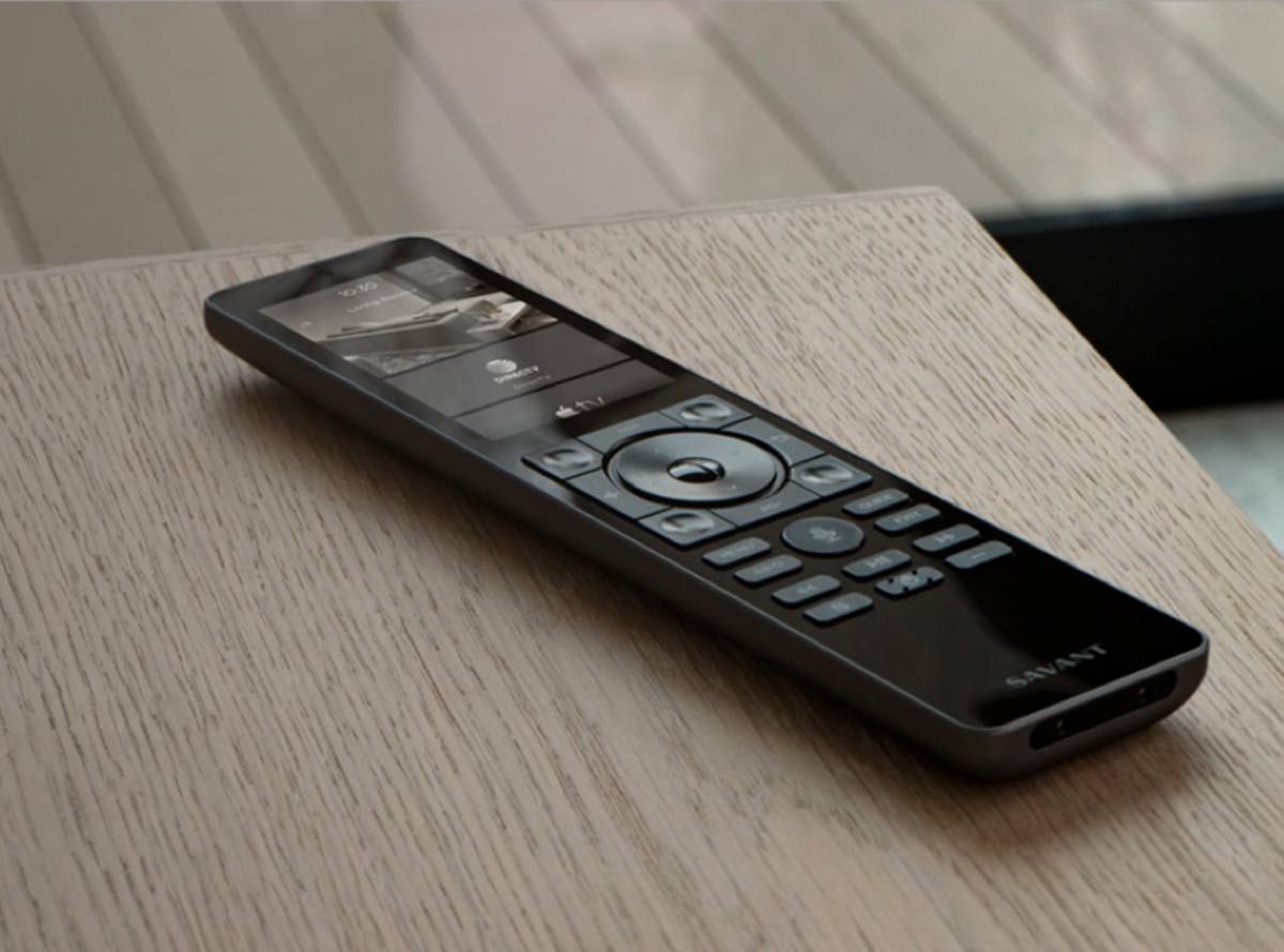 Savant Pro remote control placed on a wooden surface.
