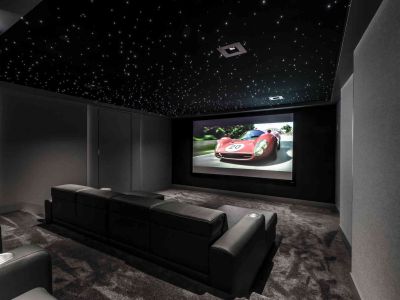 Dedicated home theater with starlight ceiling and projector with projector screen.