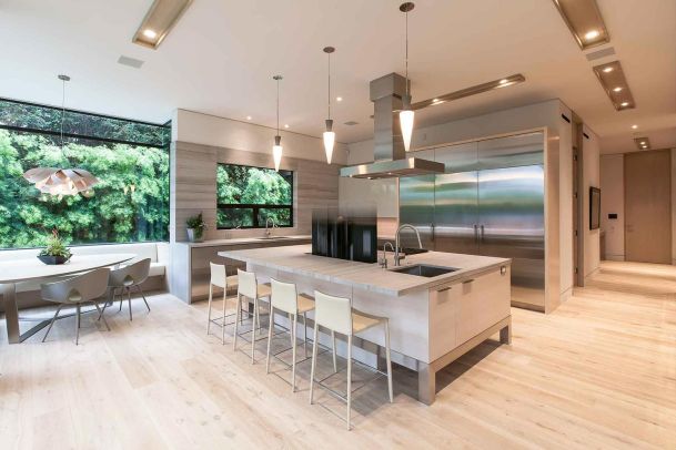 Motorized TV lift in kitchen island with controlled lighting and in-ceiling speakers