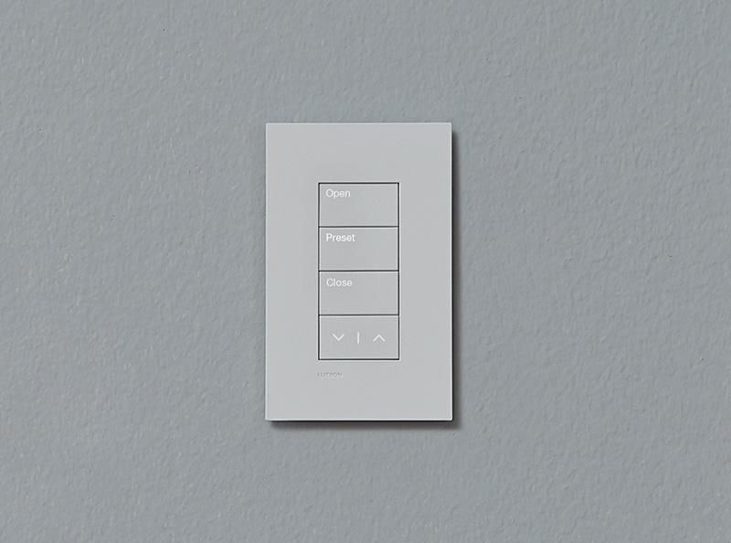 Lutron wall-mounted keypad with buttons labeled Open, Preset, Close, and directional arrows.