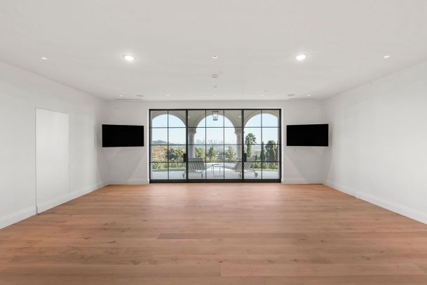 Gym Room With Mounted Dual LED TV's in Los Feliz