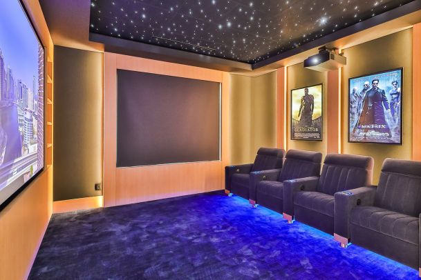 Movie theater with motorized window shades integrated through Savant System 