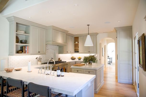 White and light green modern kitchen with in-ceiling speakers in Westlake Village